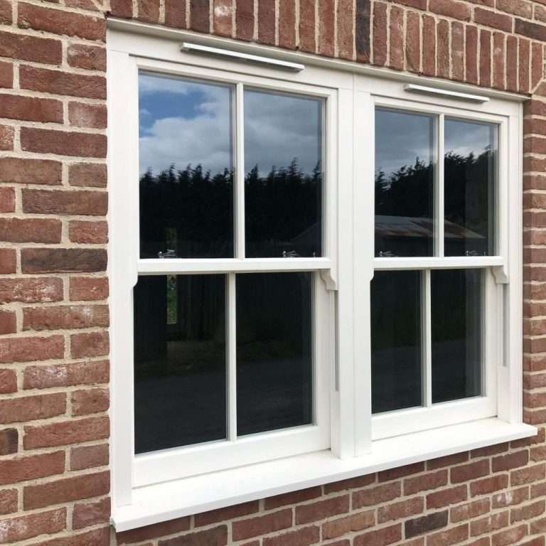 White UPVC sash windows fitted on brick property